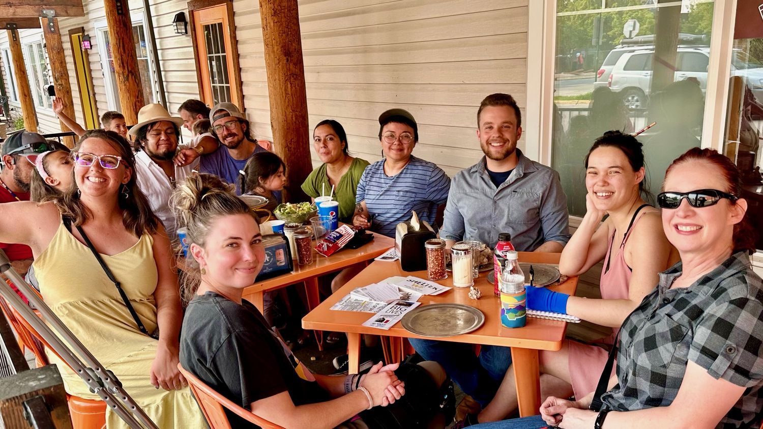Neighbors gathered around a table on a Whitefish porch.